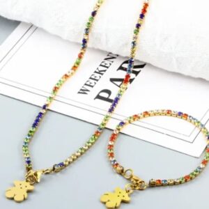 Conjunto de brillo multicolor con oso dorado